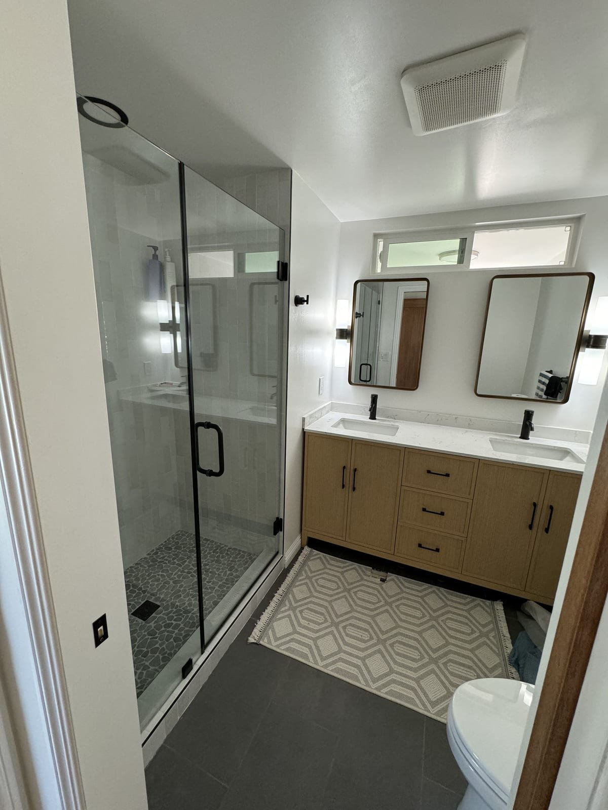 Finished bathroom with a glass shower and double vanity