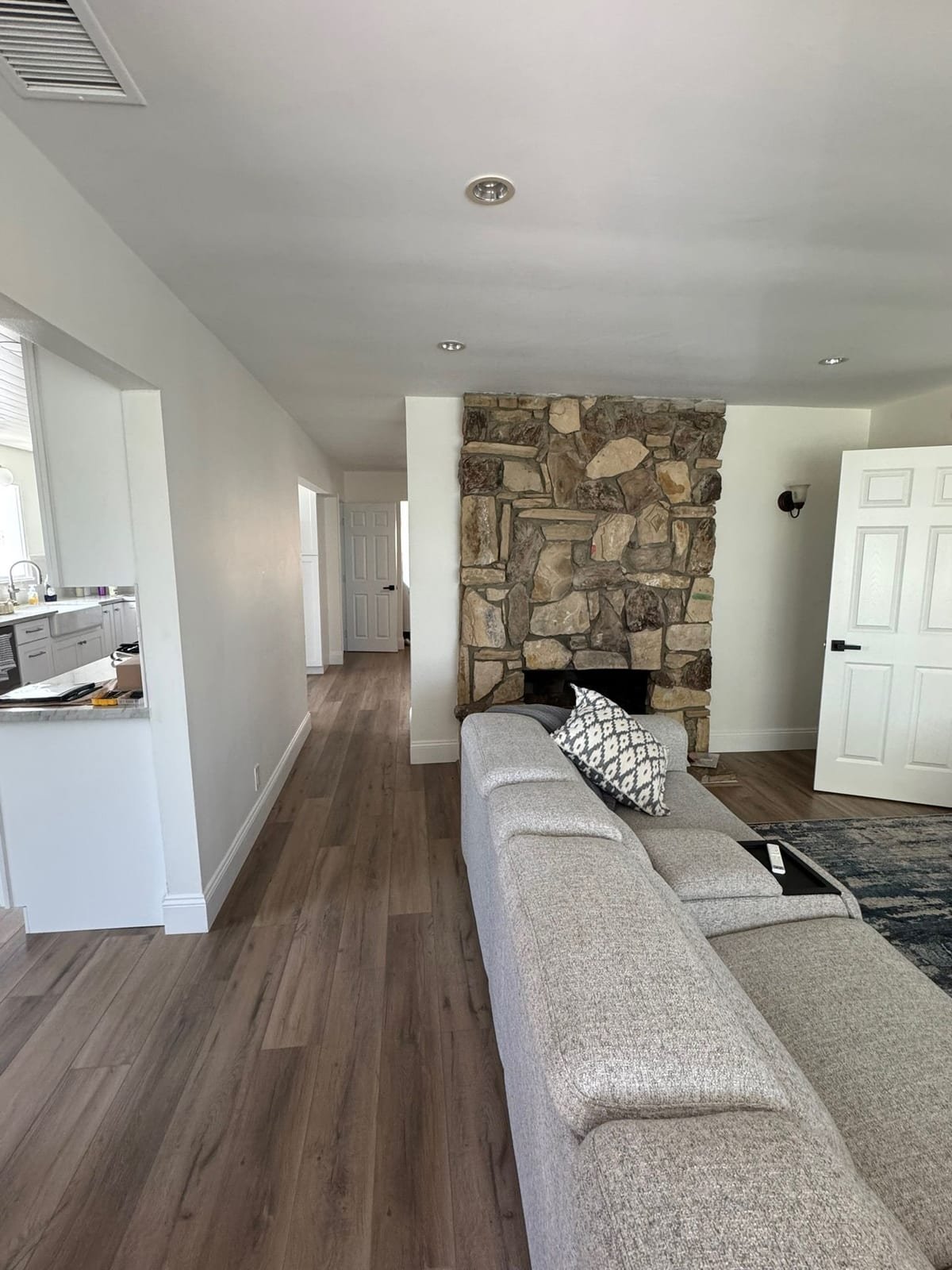 Finished living room opening to the kitchen